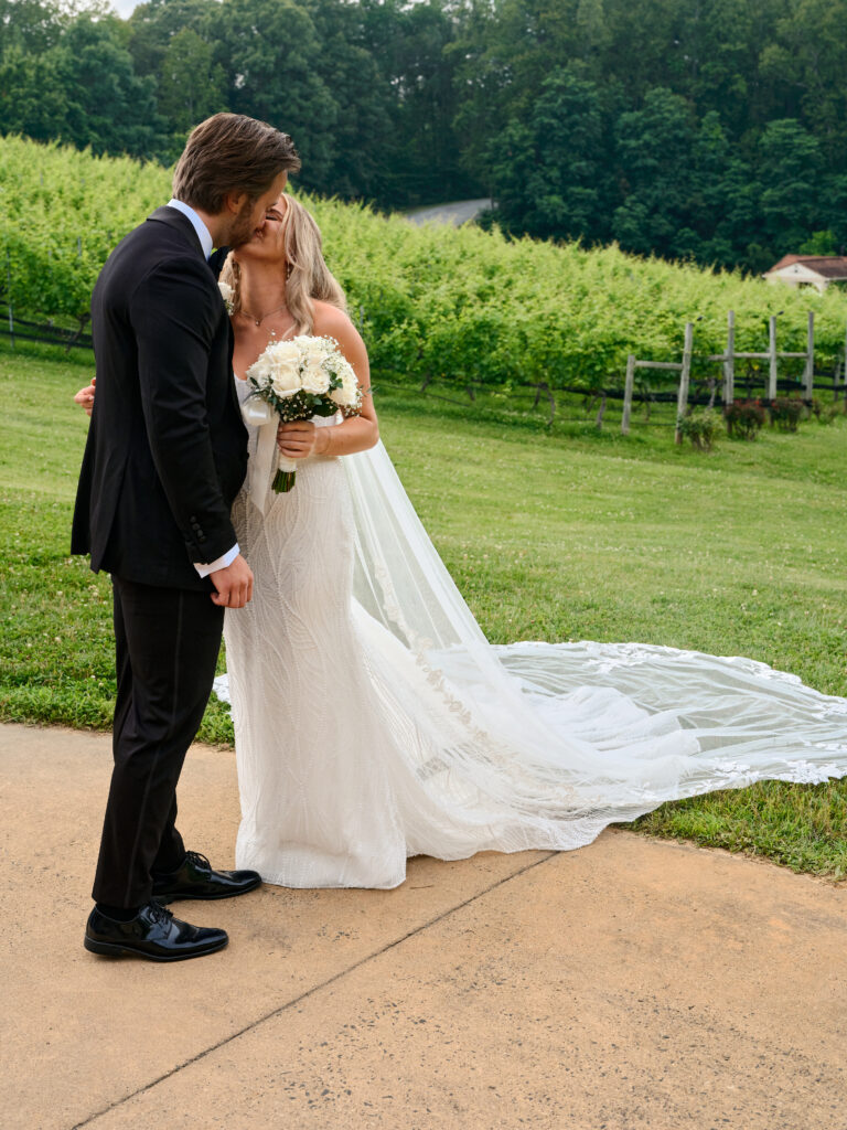 Destination wedding photographer captures first look over the vineyard at Potomac Point Winery